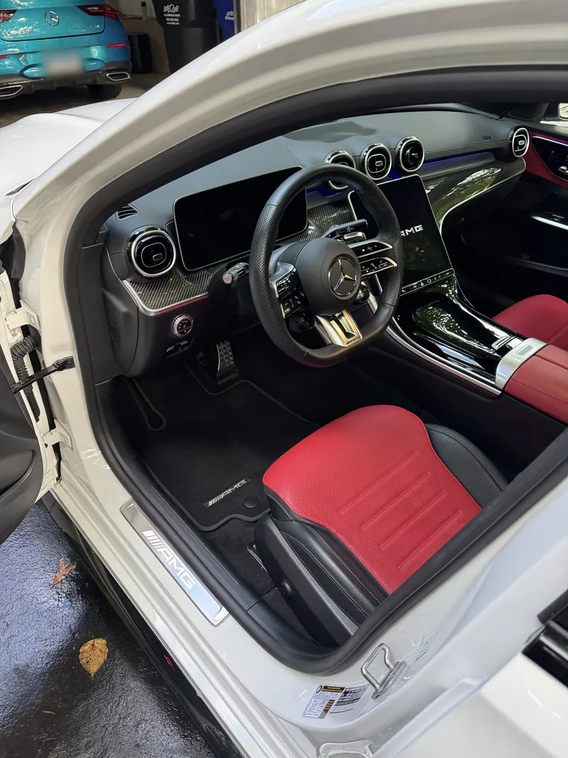 Detailed Mercedes interior with clean black carpets and red leather seats