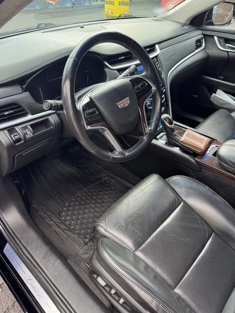 After: the Cadillac interior with a clean mat and wiped-down leather